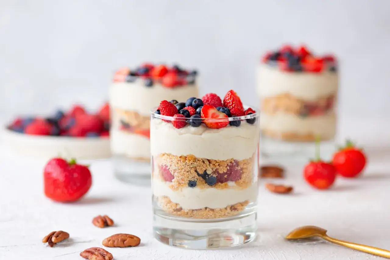 Bezglutenowe desery, stół z ciastami bez glutenu, kolorowe desery w pucharkach